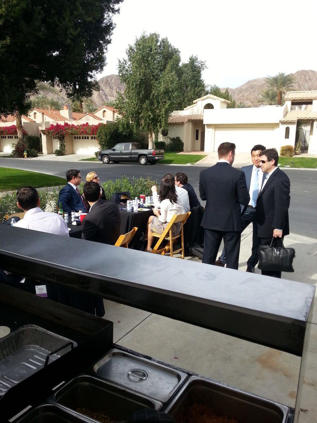 Guests being served tacos at a backyard party