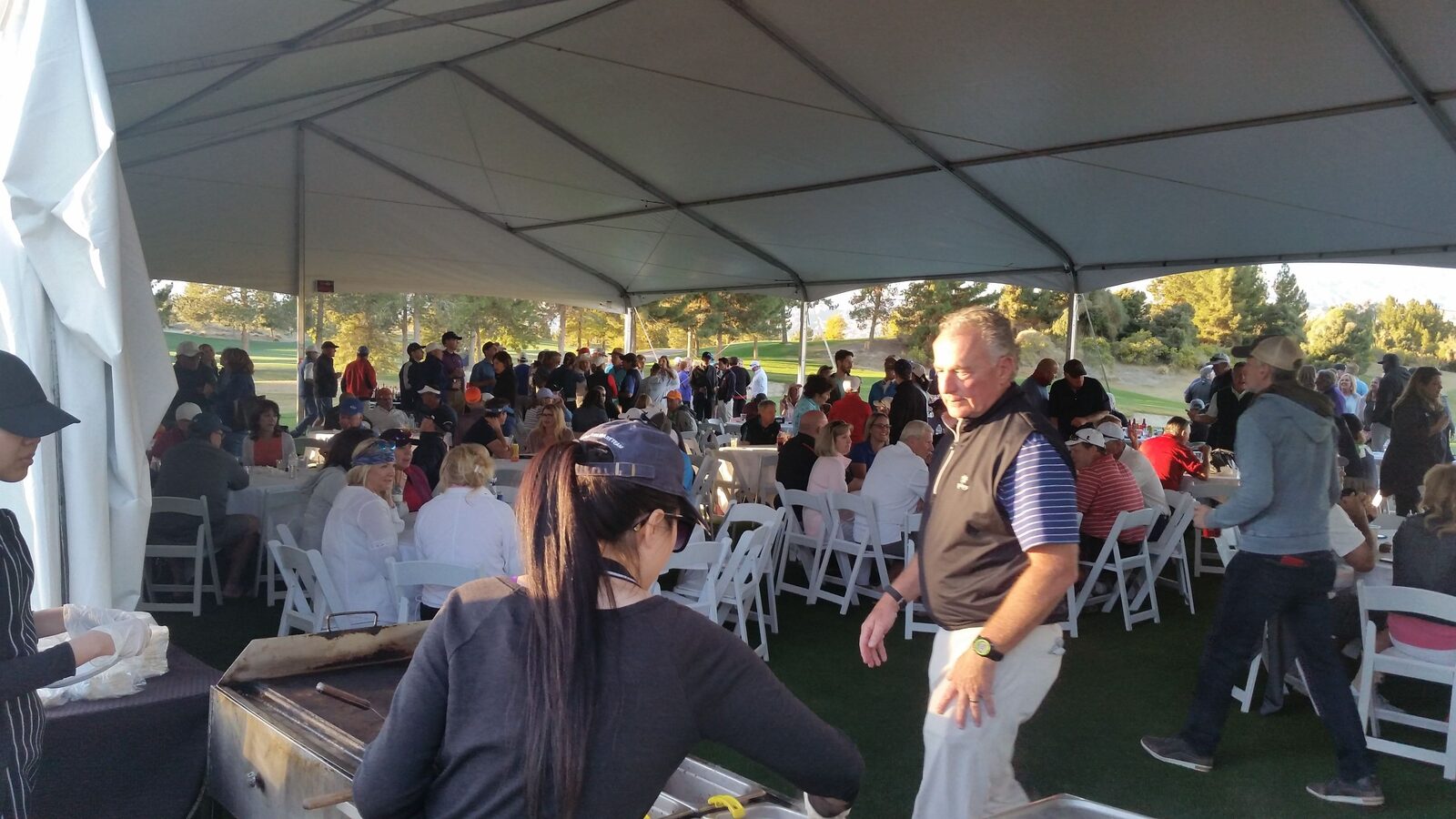 Taco catering event with a full crowd under the tent