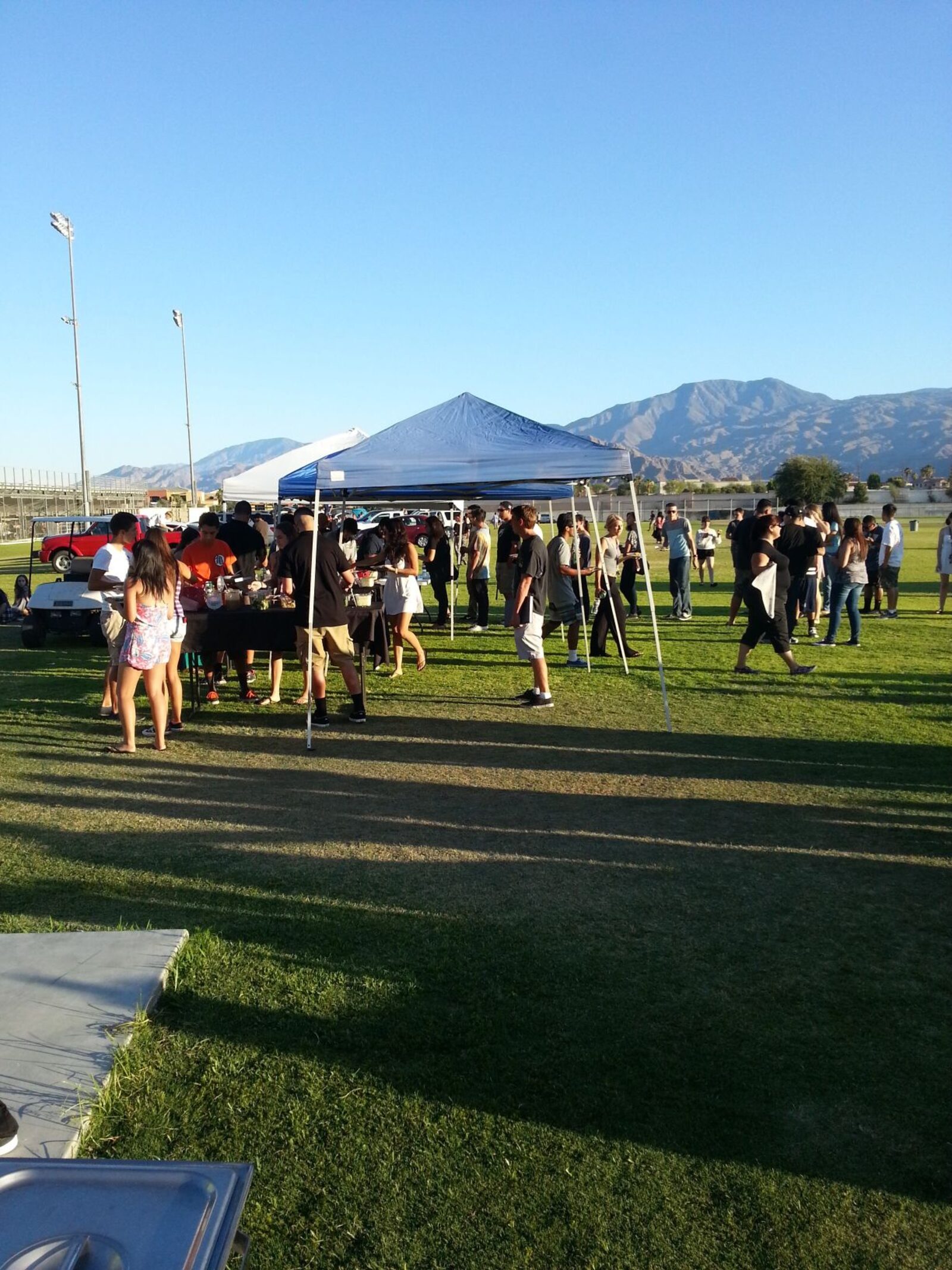 Crowd being served at an outdoor taco catering event