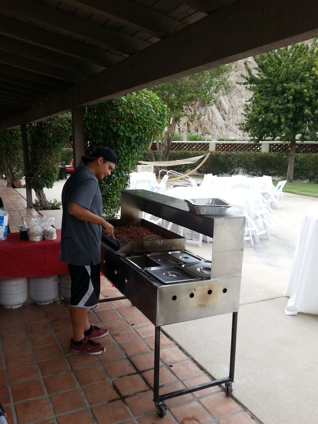 Taco cook working the griddle at a catering event