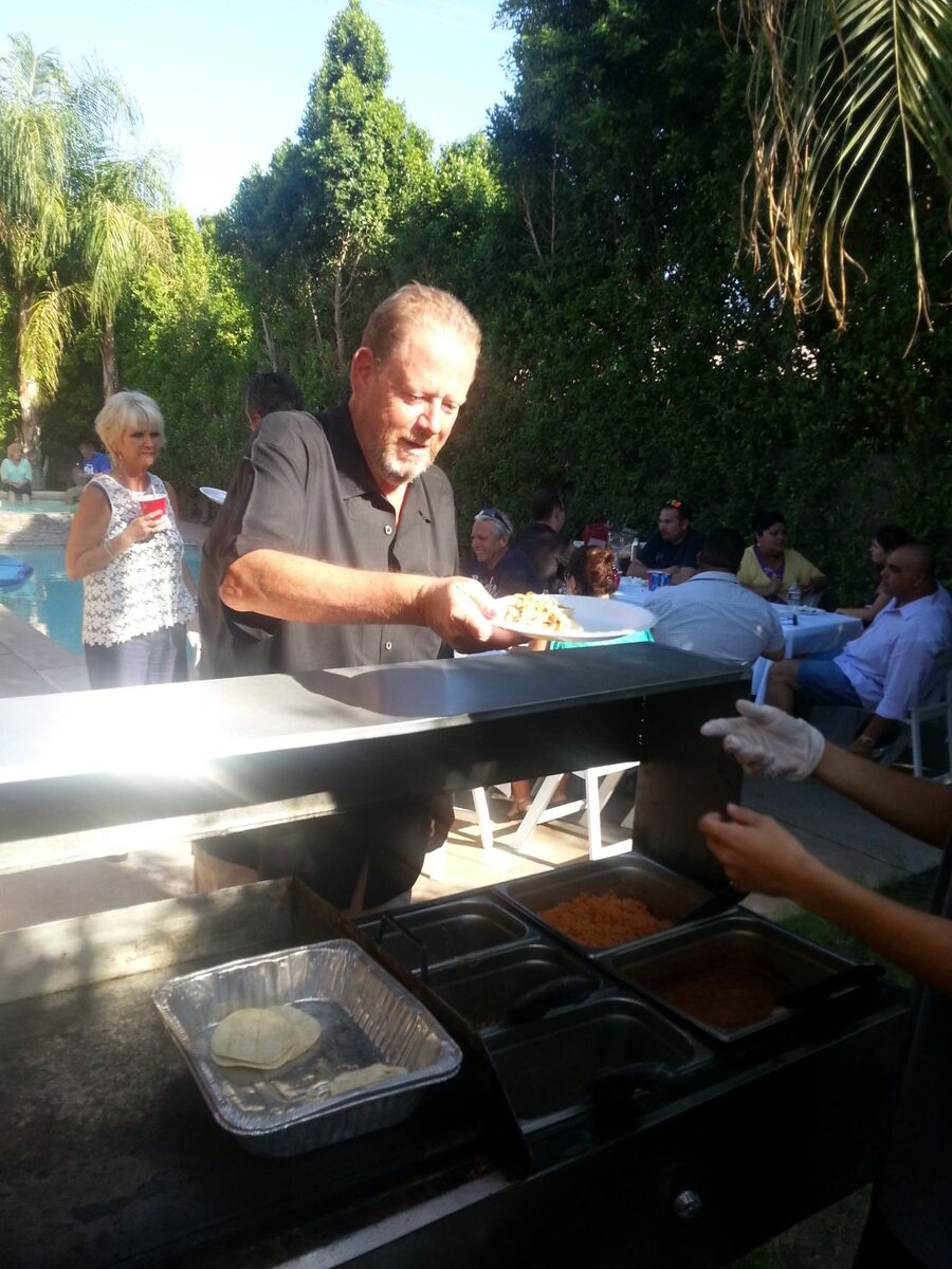 Taco caterer cooking on the grill at an event